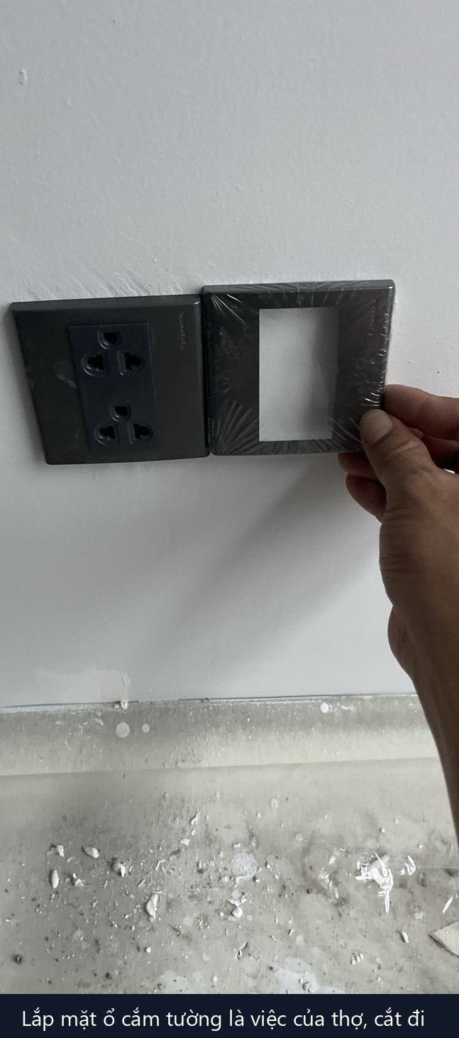 tay thợ lắp mặt ổ cắm đôi mới lên hộp âm tường